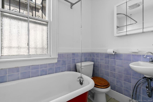 8 Academy St, New Haven, CT 06511 - bathroom with toilet, a soaking tub, plenty of natural light, a wainscoted wall, and tile walls