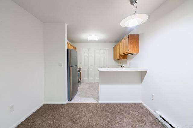 20 E Pembroke Rd Unit 55, Danbury, CT 06811 - kitchen featuring freestanding refrigerator, baseboard heating, a peninsula, light colored carpet, and baseboards