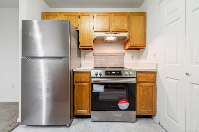 20 E Pembroke Rd Unit 55, Danbury, CT 06811 - kitchen with stainless steel appliances, under cabinet range hood, light countertops, and brown cabinetry