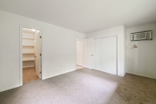 20 E Pembroke Rd Unit 55, Danbury, CT 06811 - unfurnished bedroom featuring carpet floors, a wall unit AC, and a closet