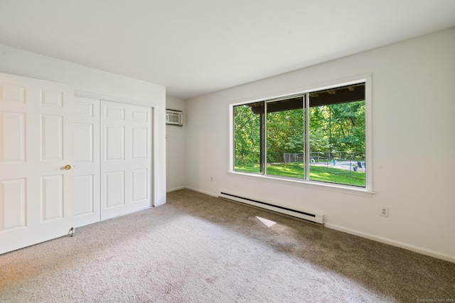 20 E Pembroke Rd Unit 55, Danbury, CT 06811 - unfurnished bedroom with a baseboard radiator, carpet, a wall unit AC, a closet, and baseboards