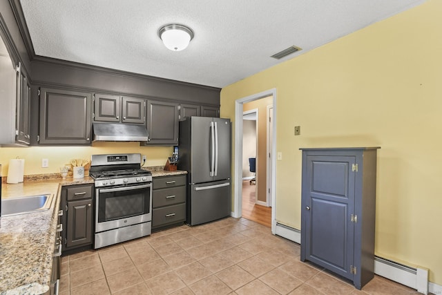 96 Flanders River Rd, Coventry, CT 06238 - kitchen featuring stainless steel appliances, a baseboard radiator, under cabinet range hood, a textured ceiling, and light tile patterned floors