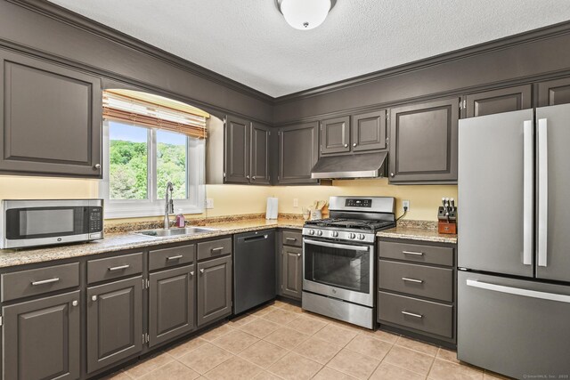96 Flanders River Rd, Coventry, CT 06238 - kitchen with stainless steel appliances, under cabinet range hood, a sink, light tile patterned floors, and a textured ceiling