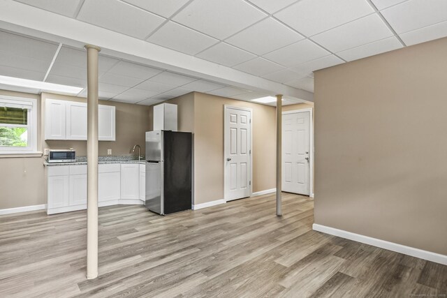 96 Flanders River Rd, Coventry, CT 06238 - kitchen with appliances with stainless steel finishes, a drop ceiling, baseboards, light wood-style flooring, and white cabinetry