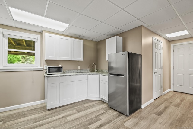 96 Flanders River Rd, Coventry, CT 06238 - kitchen with appliances with stainless steel finishes, a drop ceiling, light wood-style floors, baseboards, and a sink