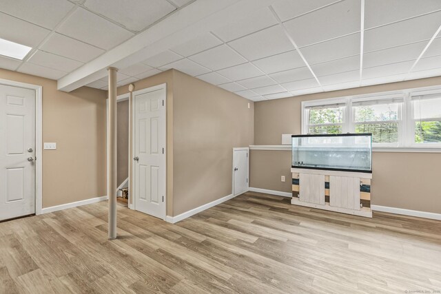 96 Flanders River Rd, Coventry, CT 06238 - unfurnished living room with a drop ceiling, wood finished floors, and baseboards