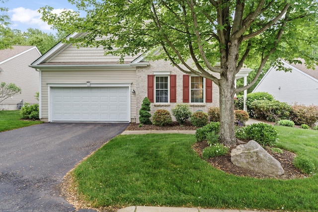 403 Mulligan Dr Unit 403, Oxford, CT 06478 - view of front of home featuring driveway, a front yard, and an attached garage