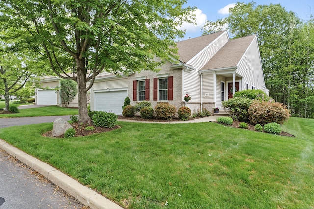 403 Mulligan Dr Unit 403, Oxford, CT 06478 - view of property hidden behind natural elements with an attached garage, asphalt driveway, a front yard, roof with shingles, and brick siding