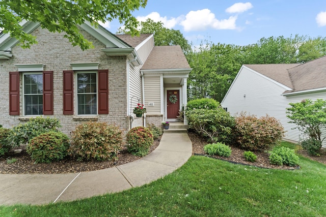 403 Mulligan Dr Unit 403, Oxford, CT 06478 - view of front of house with a front yard, roof with shingles, and brick siding