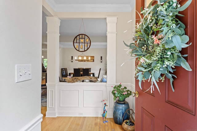 403 Mulligan Dr Unit 403, Oxford, CT 06478 - bar featuring a chandelier, light wood-style flooring, ornamental molding, and decorative light fixtures