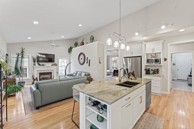 403 Mulligan Dr Unit 403, Oxford, CT 06478 - kitchen with stainless steel appliances, a sink, vaulted ceiling, open shelves, and a ceiling fan