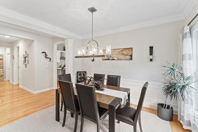 403 Mulligan Dr Unit 403, Oxford, CT 06478 - dining area with a chandelier, light wood-type flooring, ornamental molding, and wainscoting
