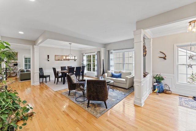403 Mulligan Dr Unit 403, Oxford, CT 06478 - living area featuring a chandelier, light wood finished floors, a wainscoted wall, ornamental molding, and recessed lighting