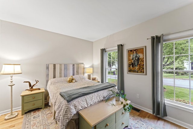 403 Mulligan Dr Unit 403, Oxford, CT 06478 - bedroom featuring multiple windows, light wood-type flooring, and baseboards