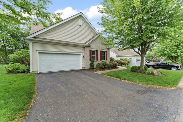 403 Mulligan Dr Unit 403, Oxford, CT 06478 - view of front of house with asphalt driveway, an attached garage, and a front lawn