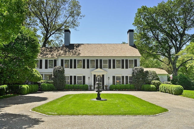 276 Greenley Rd, New Canaan, CT 06840 - colonial inspired home with a chimney, a front lawn, and curved driveway