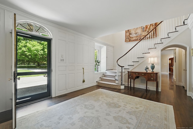 276 Greenley Rd, New Canaan, CT 06840 - foyer entrance with stairway, dark wood finished floors, arched walkways, and baseboards