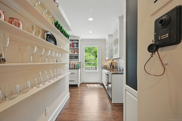 276 Greenley Rd, New Canaan, CT 06840 - bar featuring ornamental molding, dark wood-style flooring, recessed lighting, and stainless steel microwave