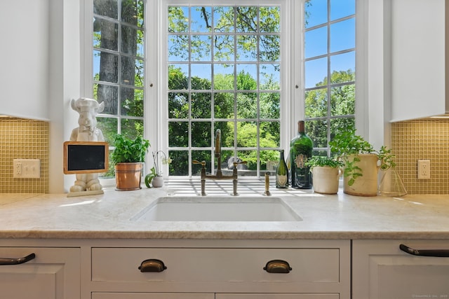 276 Greenley Rd, New Canaan, CT 06840 - kitchen with a sink, backsplash, white cabinetry, and light stone counters