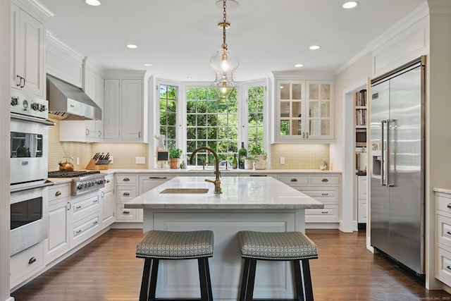 276 Greenley Rd, New Canaan, CT 06840 - kitchen with appliances with stainless steel finishes, backsplash, white cabinets, recessed lighting, and crown molding