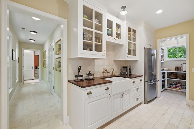 276 Greenley Rd, New Canaan, CT 06840 - kitchen featuring freestanding refrigerator, a sink, backsplash, glass insert cabinets, and white cabinets