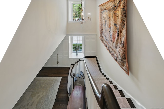 276 Greenley Rd, New Canaan, CT 06840 - staircase with a chandelier, wood finished floors, plenty of natural light, and a decorative wall