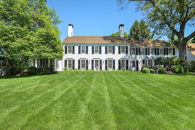 276 Greenley Rd, New Canaan, CT 06840 - colonial house featuring a front yard and a chimney