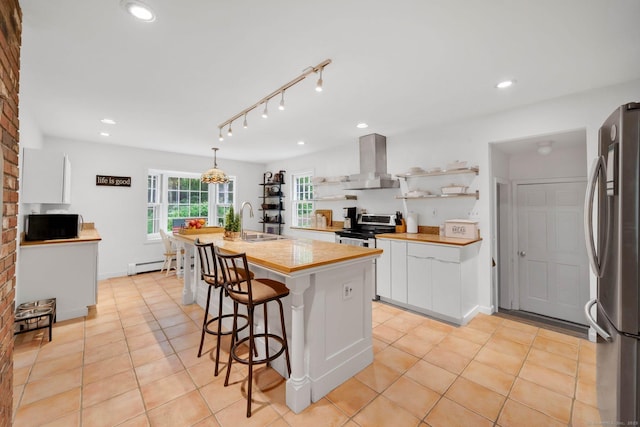 6 Cedar Cir, Newtown, CT 06470 - kitchen featuring stainless steel appliances, island exhaust hood, a sink, a baseboard heating unit, and white cabinetry