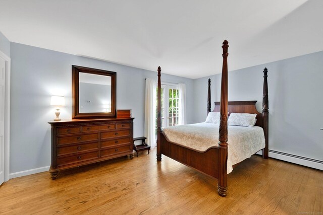 6 Cedar Cir, Newtown, CT 06470 - bedroom with light wood-style flooring, a baseboard heating unit, and baseboards