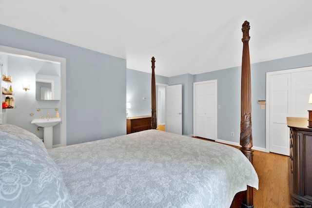 6 Cedar Cir, Newtown, CT 06470 - bedroom featuring wood finished floors, a sink, ensuite bath, and baseboards