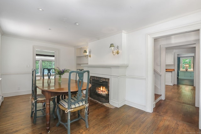 708 Ponus Rdg, New Canaan, CT 06840 - dining space with crown molding, wood finished floors, a brick fireplace, and baseboards