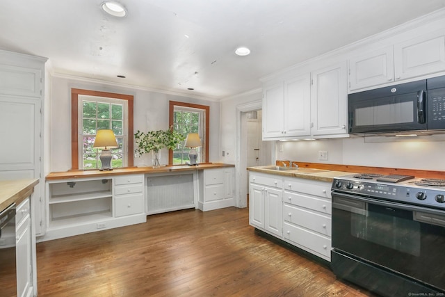 708 Ponus Rdg, New Canaan, CT 06840 - kitchen with black microwave, electric range oven, butcher block counters, white cabinets, and ornamental molding