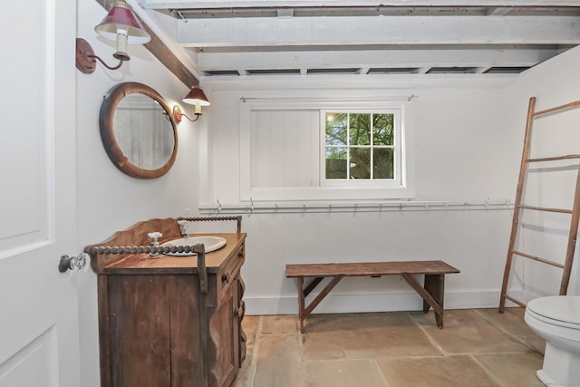 708 Ponus Rdg, New Canaan, CT 06840 - bathroom with a sink, toilet, beam ceiling, and stone finish floors