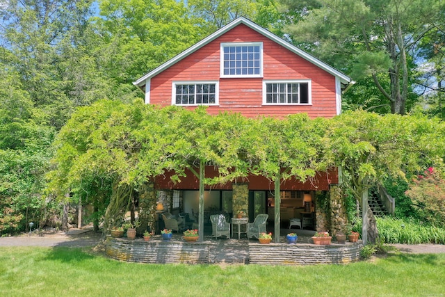 708 Ponus Rdg, New Canaan, CT 06840 - back of house with stone siding and a patio