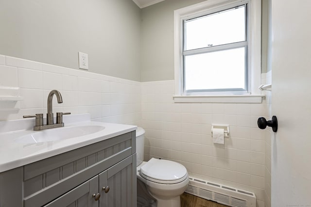 79 Arrowbrook Rd, Windsor, CT 06095 - bathroom with toilet, tile walls, vanity, plenty of natural light, and a wainscoted wall