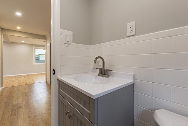 79 Arrowbrook Rd, Windsor, CT 06095 - half bath with wood finished floors, tile walls, vanity, toilet, and recessed lighting