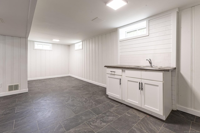 79 Arrowbrook Rd, Windsor, CT 06095 - basement with a sink and wooden walls