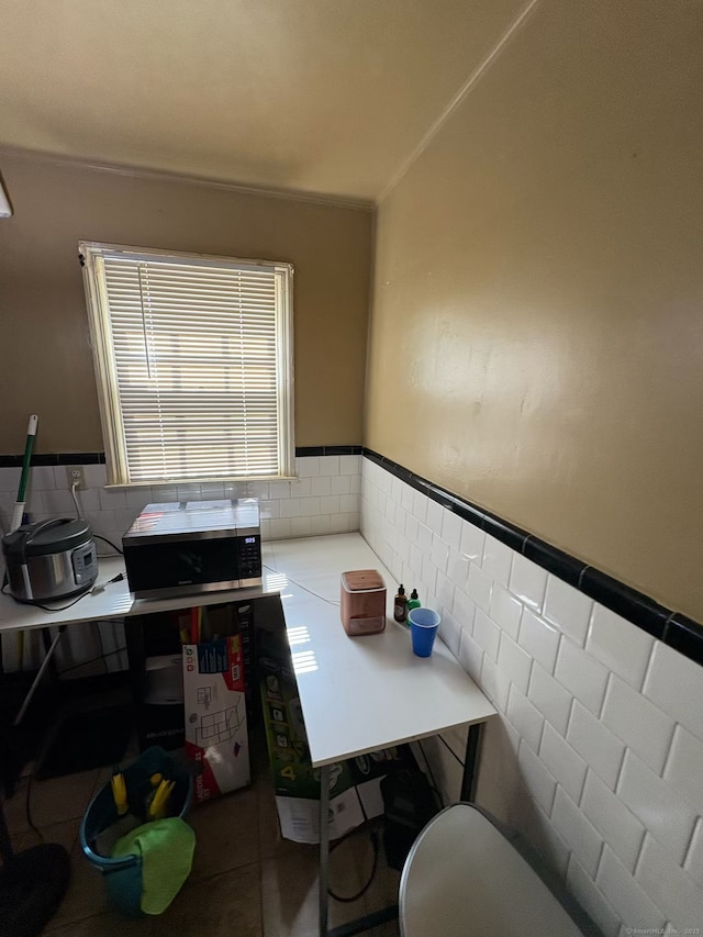 647 Fountain St, New Haven, CT 06515 - tiled dining space with a wainscoted wall, ornamental molding, and tile walls
