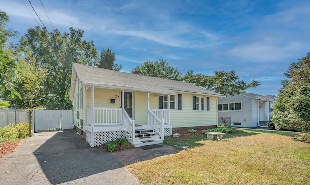 29 Risley St, East Hartford, CT 06118 - view of front of house featuring covered porch, a chimney, and a shingled roof