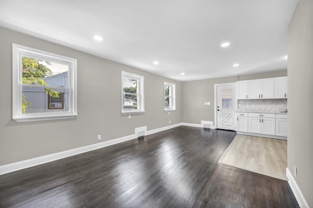29 Risley St, East Hartford, CT 06118 - unfurnished living room featuring healthy amount of natural light, dark wood-style flooring, baseboards, and recessed lighting