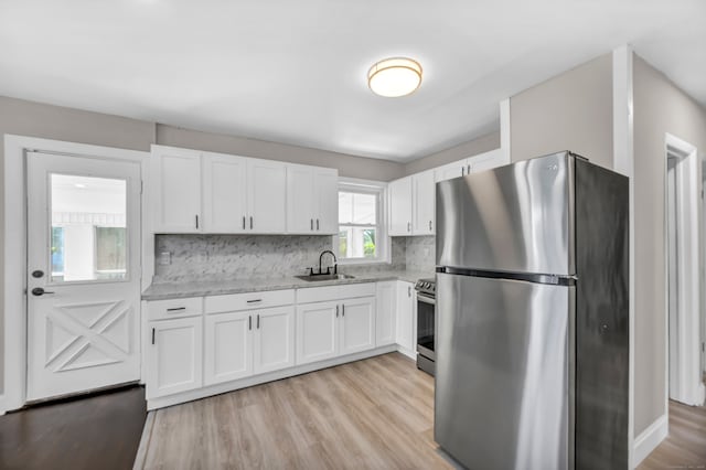 29 Risley St, East Hartford, CT 06118 - kitchen featuring stainless steel appliances, a sink, white cabinetry, and tasteful backsplash