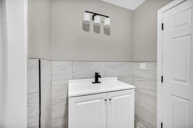 29 Risley St, East Hartford, CT 06118 - bathroom featuring tile walls, vanity, and a wainscoted wall