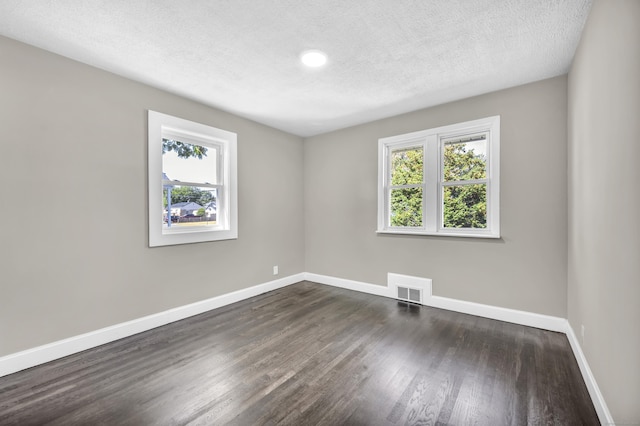 29 Risley St, East Hartford, CT 06118 - unfurnished room featuring healthy amount of natural light, baseboards, dark wood-style floors, and a textured ceiling