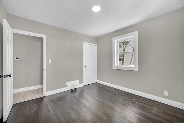 29 Risley St, East Hartford, CT 06118 - unfurnished room featuring baseboards, dark wood finished floors, and a textured ceiling