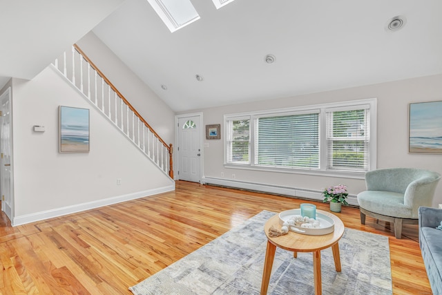 5 Wildmere Ln, Norwalk, CT 06851 - living room featuring stairway, wood finished floors, a skylight, a baseboard radiator, and vaulted ceiling