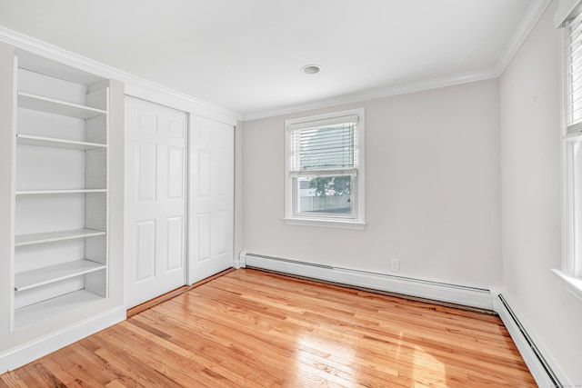 5 Wildmere Ln, Norwalk, CT 06851 - unfurnished bedroom with a baseboard heating unit, light wood-type flooring, ornamental molding, a baseboard radiator, and a closet