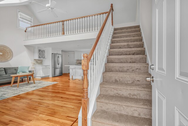 5 Wildmere Ln, Norwalk, CT 06851 - staircase featuring wood finished floors, a ceiling fan, and a towering ceiling