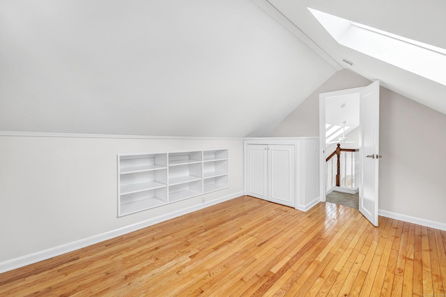 5 Wildmere Ln, Norwalk, CT 06851 - bonus room featuring a skylight, hardwood / wood-style flooring, built in features, lofted ceiling, and baseboards