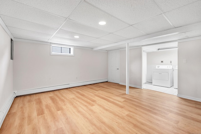 5 Wildmere Ln, Norwalk, CT 06851 - basement with a paneled ceiling, wood finished floors, a baseboard heating unit, washing machine and dryer, and baseboards