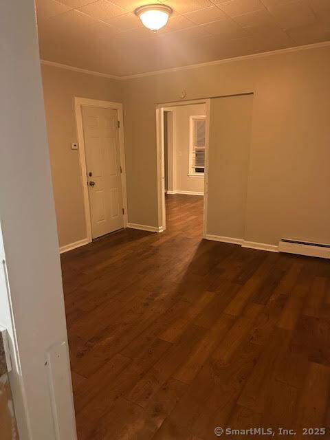 40 Orchard St, Bristol, CT 06010 - empty room with crown molding, dark wood-style floors, a baseboard heating unit, and baseboards